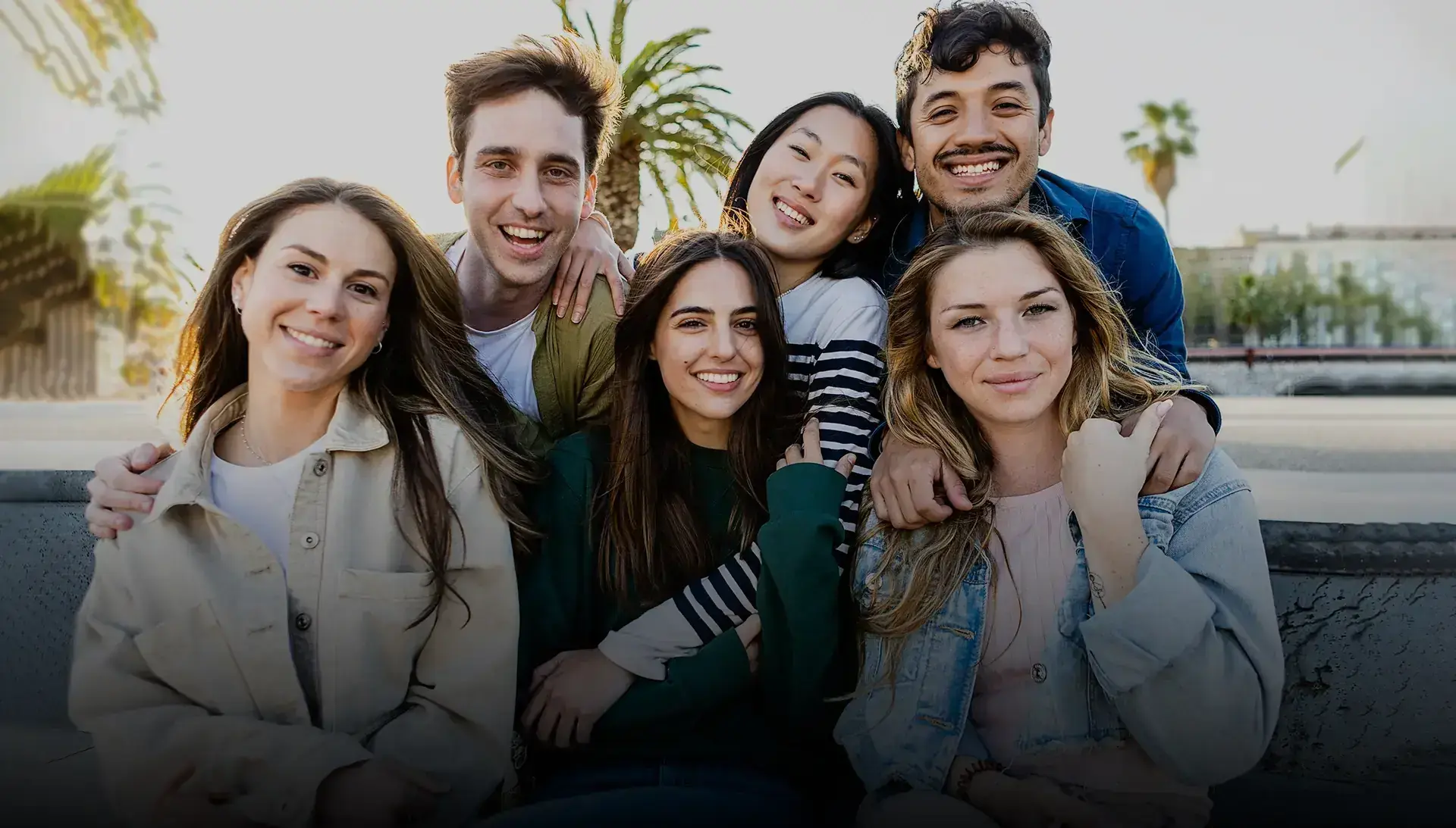 A group of friends sharing bright smiles outdoors
